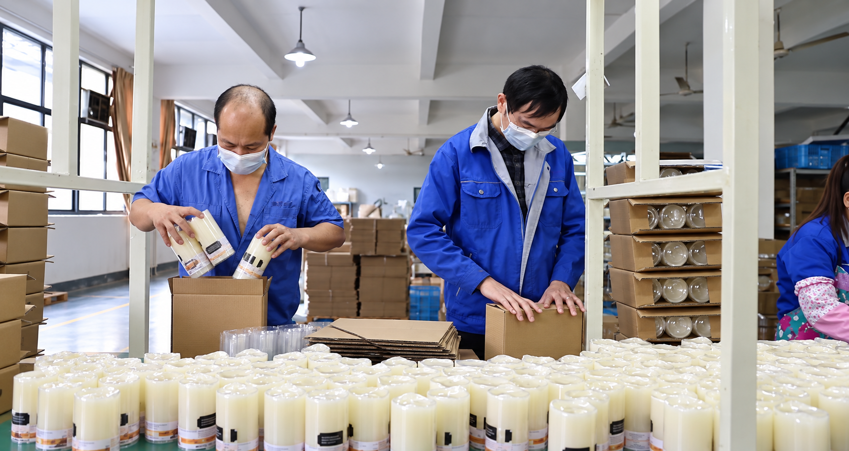 Langsheng workers inspecting and packing candle products
